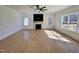 Bright living room with hardwood floors, a modern fireplace, and large windows offering natural light at 727 Cook Rd, Durham, NC 27713