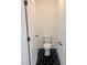 Powder room featuring hexagon tile flooring, white walls, and modern fixtures at 727 Cook Rd, Durham, NC 27713