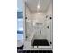 Shower with frameless glass door, built-in bench, and modern fixtures at 727 Cook Rd, Durham, NC 27713