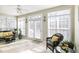 Bright sunroom with wicker furniture and access to the outdoors at 101 Quarryrock Rd, Holly Springs, NC 27540