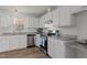 Modern kitchen featuring white cabinets, stainless steel appliances, and granite countertops at 102 Anderson Dr, Wake Forest, NC 27587