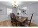 Charming dining room boasts traditional wood furniture and natural lighting at 122 Westwood Pl, Clayton, NC 27520