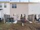 Back patio featuring patio table and chairs; trash cans, fence, and grass in the background at 125 Watertree Ln, Apex, NC 27502
