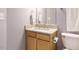 Bathroom featuring granite countertop, wooden cabinetry, and white toilet at 125 Watertree Ln, Apex, NC 27502
