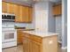 Well-lit kitchen with granite counters, island, and stainless steel microwave and range at 125 Watertree Ln, Apex, NC 27502