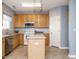 Cozy kitchen with stainless steel appliances, granite countertops, and center island at 125 Watertree Ln, Apex, NC 27502