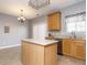 Bright kitchen featuring tile flooring, granite countertops, and stainless steel sink at 125 Watertree Ln, Apex, NC 27502
