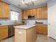 Bright kitchen featuring granite countertops, stainless steel appliances, and island at 125 Watertree Ln, Apex, NC 27502