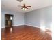 Open living area with hardwood floors, leading to the kitchen, with neutral wall color at 125 Watertree Ln, Apex, NC 27502