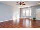 Spacious living room with hardwood floors, bright natural light, and neutral wall color at 125 Watertree Ln, Apex, NC 27502
