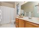 Well-lit bathroom with a spacious vanity, shower curtain, and large mirror at 1300 Durlain Dr # 108, Raleigh, NC 27614