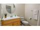 Cozy bathroom featuring a wooden vanity with an oval mirror and adjacent toilet at 1300 Durlain Dr # 108, Raleigh, NC 27614