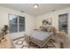 Bright bedroom with natural light, two windows with a gray bed, and stylish decor at 1300 Durlain Dr # 108, Raleigh, NC 27614