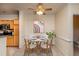 Dining room with white table and chairs, ceiling fan, and adjacent kitchen with stainless steel appliances at 1300 Durlain Dr # 108, Raleigh, NC 27614