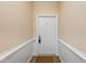 A white-painted unit door on a light-carpeted hallway with white trim at 1300 Durlain Dr # 108, Raleigh, NC 27614