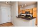 Kitchen with breakfast bar featuring stainless appliances, granite countertops, and wood cabinets at 1300 Durlain Dr # 108, Raleigh, NC 27614
