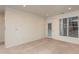 Bright living room featuring a door to the outside and large window with blinds for natural light at 1300 Durlain Dr # 108, Raleigh, NC 27614