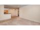 Spacious living room with neutral walls, carpeting, and a view into the kitchen and bathroom at 1300 Durlain Dr # 108, Raleigh, NC 27614