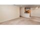 Expansive living room with neutral colors, carpeting, and a partial view of the kitchen at 1300 Durlain Dr # 108, Raleigh, NC 27614