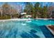 Community pool with water slide and surrounding trees at 1300 Durlain Dr # 108, Raleigh, NC 27614