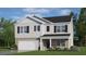Two-story house with gray siding, brick accents, and a two-car garage at 180 Paper Birch Way, Fuquay Varina, NC 27526