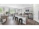 Open concept kitchen with granite countertops, gray cabinets, and stainless steel appliances at 180 Paper Birch Way, Fuquay Varina, NC 27526
