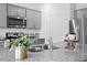 Kitchen island with granite countertop and double sink, gray cabinets at 180 Paper Birch Way, Fuquay Varina, NC 27526