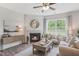 Bright living room features a fireplace, large windows, and comfy seating at 180 Paper Birch Way, Fuquay Varina, NC 27526