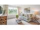 Living room featuring a sofa, coffee table, and large window at 180 Paper Birch Way, Fuquay Varina, NC 27526