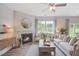 Bright living room features a fireplace, large windows, and comfy seating at 180 Paper Birch Way, Fuquay Varina, NC 27526
