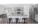 Modern kitchen with gray cabinets, granite countertops, and an island with seating at 197 Paper Birch Way, Fuquay Varina, NC 27526