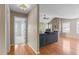 Hallway with wood floors and access to living room and bedroom at 2523 Wellington Ridge Loop, Cary, NC 27518