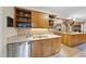 Well lit kitchen featuring wood cabinets, stainless steel appliances, tile backsplash and light countertops at 2706 Rosedale Ave, Raleigh, NC 27607