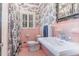 Charming bathroom with pink tile, a pedestal sink, and toile wallpaper at 2801 Chelsea Cir, Durham, NC 27707