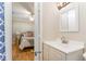 Simple bathroom with white vanity and a view into a bedroom at 2801 Chelsea Cir, Durham, NC 27707