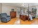 Bright bedroom with hardwood floors, a comfortable armchair, and a four-poster bed at 2801 Chelsea Cir, Durham, NC 27707