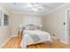 Cozy bedroom with hardwood floors, a ceiling fan, and neutral color tones at 2801 Chelsea Cir, Durham, NC 27707