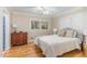 Serene bedroom with hardwood floors, a ceiling fan, and neutral color tones at 2801 Chelsea Cir, Durham, NC 27707