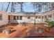 Spacious red brick patio with metal table and chairs, surrounded by lush greenery at 2801 Chelsea Cir, Durham, NC 27707