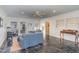 Bright sunroom with blue sofas, a writing desk, and marble flooring at 2801 Chelsea Cir, Durham, NC 27707