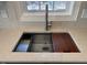 Close up of kitchen sink with new faucet, countertop, and cutting board at 3212 Potthast Ct, Raleigh, NC 27616