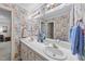 Bathroom with floral wallpaper, double sinks, and ample counter space, blending vintage charm with functionality at 3347 Ridgecrest Ct, Raleigh, NC 27607