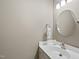 Powder room featuring a white vanity, round mirror, and neutral color scheme at 3347 Ridgecrest Ct, Raleigh, NC 27607
