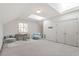 Bright bonus room with skylights, desk, seating, and double-door closet at 3347 Ridgecrest Ct, Raleigh, NC 27607