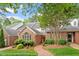 Charming brick home with landscaped front yard, a brick walkway, and mature tree at 3347 Ridgecrest Ct, Raleigh, NC 27607