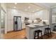 Bright kitchen featuring white cabinets, granite countertops, and stainless steel appliances at 3347 Ridgecrest Ct, Raleigh, NC 27607