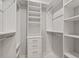 Organized walk-in closet with built-in shelving and drawers, maximizing storage and functionality at 3347 Ridgecrest Ct, Raleigh, NC 27607