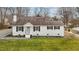 Charming exterior of a one story white home featuring manicured landscaping and a well kept green lawn at 407 Westgate Dr, Elon, NC 27244