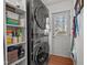 Convenient laundry room with a stacked washer and dryer and ample storage space on the built in shelves at 407 Westgate Dr, Elon, NC 27244