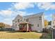 Exterior view of a home showcasing a backyard and screened porch at 4703 Paces Ferry Dr, Durham, NC 27712